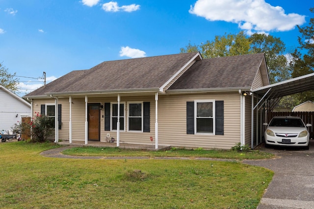 ranch-style home featuring a front lawn, a carport, and covered porch