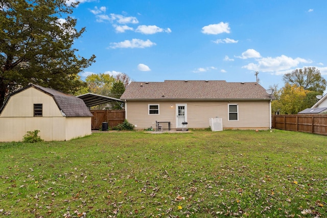 rear view of property with a storage unit and a lawn