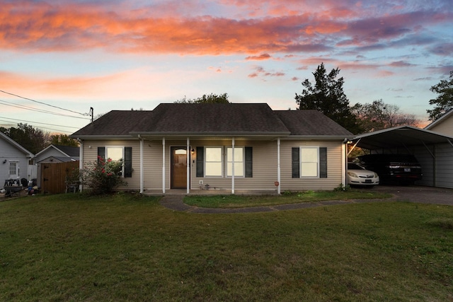 view of front of house featuring a carport, a yard, and a porch