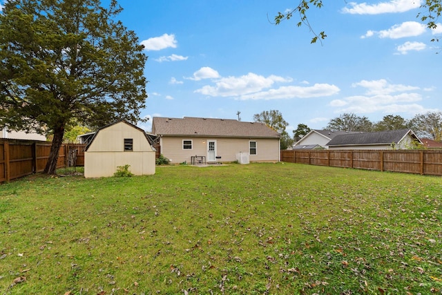 rear view of property with a storage shed and a lawn