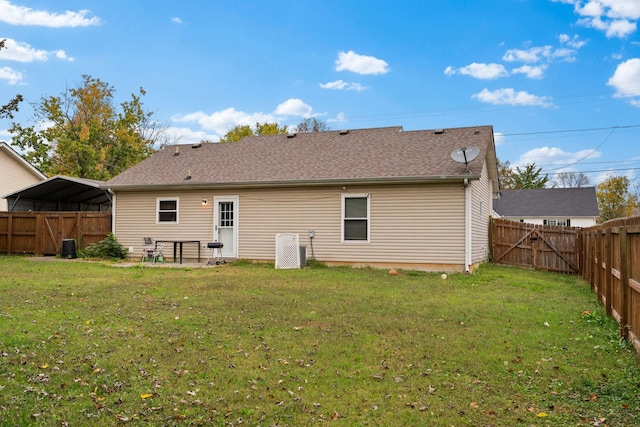 rear view of house featuring a yard and a patio area