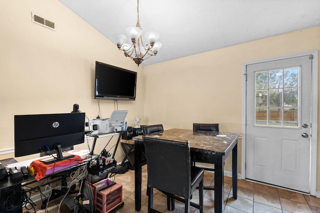 dining space with tile patterned floors and a chandelier