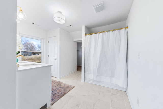 bathroom featuring vanity and shower / bathtub combination with curtain