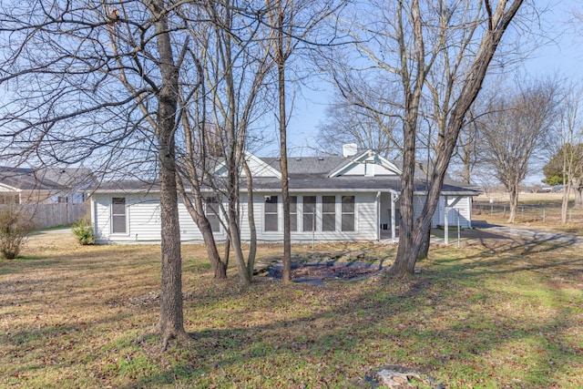 rear view of property featuring a yard