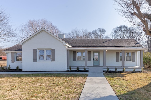 view of front of home with a porch and a front yard