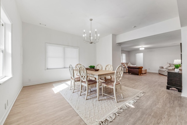 dining room with an inviting chandelier and light hardwood / wood-style floors