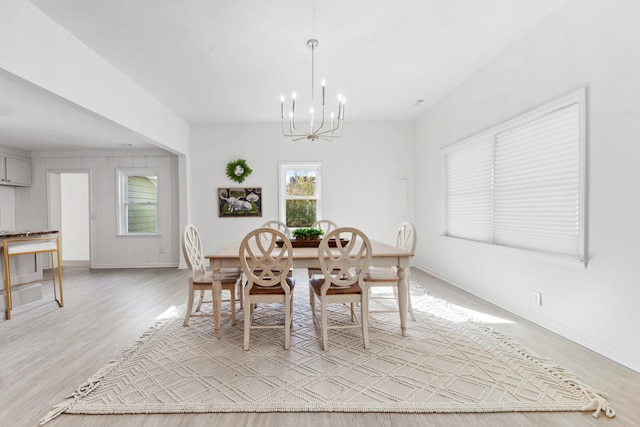 dining room featuring light hardwood / wood-style flooring and a chandelier