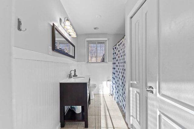 bathroom with tile patterned flooring, vanity, a shower with curtain, and toilet