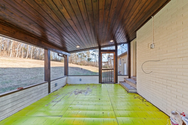 unfurnished sunroom with wood ceiling