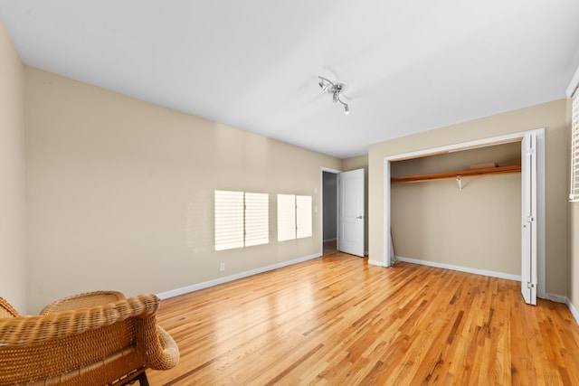 unfurnished bedroom featuring light hardwood / wood-style floors and a closet