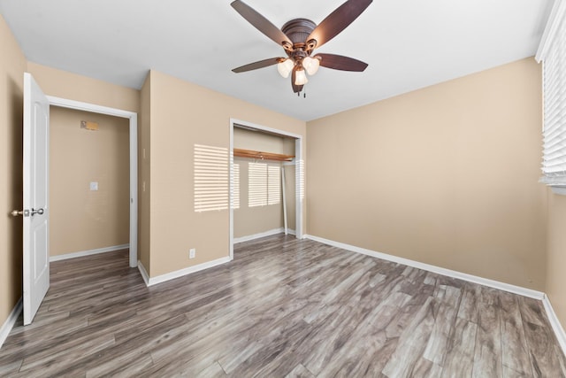 unfurnished bedroom with hardwood / wood-style floors, ceiling fan, and a closet