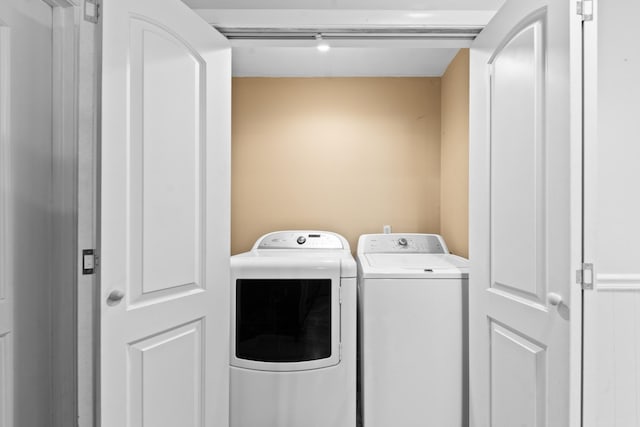 washroom featuring washer and clothes dryer