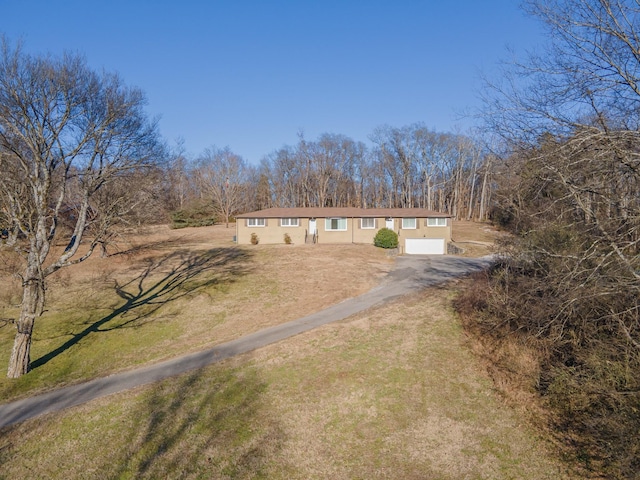 view of front of house with a garage and a front lawn