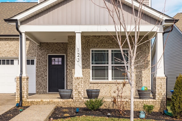 doorway to property with a garage and covered porch