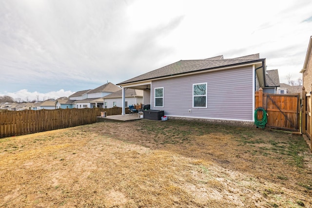 rear view of house featuring a patio and a lawn