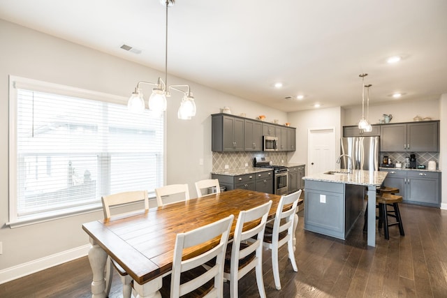 dining area featuring dark wood-type flooring