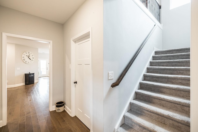 stairway with hardwood / wood-style flooring