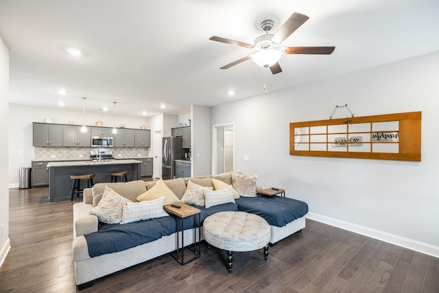 living room with dark hardwood / wood-style floors and ceiling fan