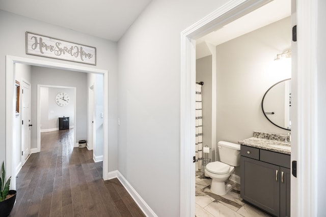 hall with hardwood / wood-style flooring and sink