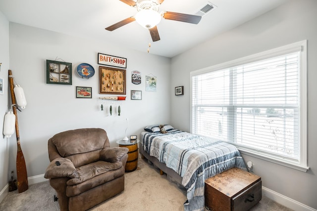 bedroom with multiple windows, light carpet, and ceiling fan