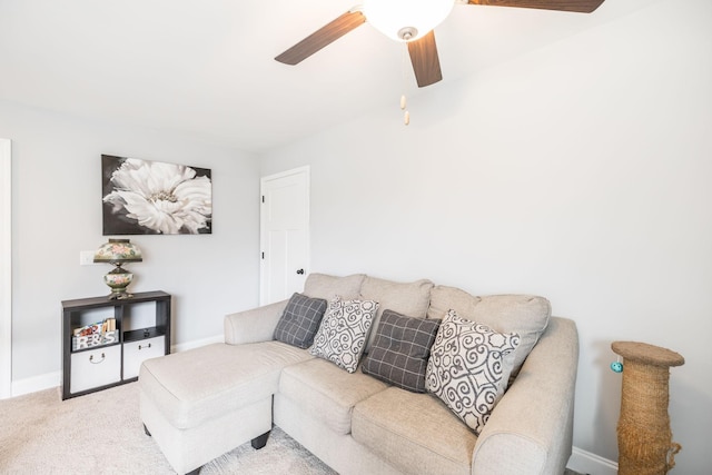 carpeted living room with ceiling fan