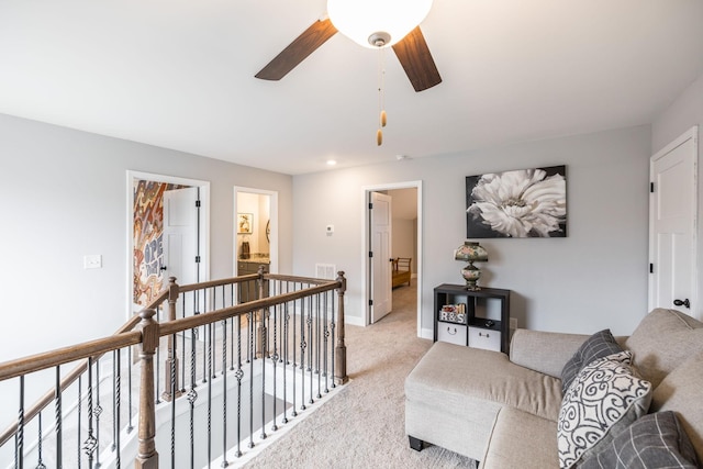 living room featuring light colored carpet and ceiling fan