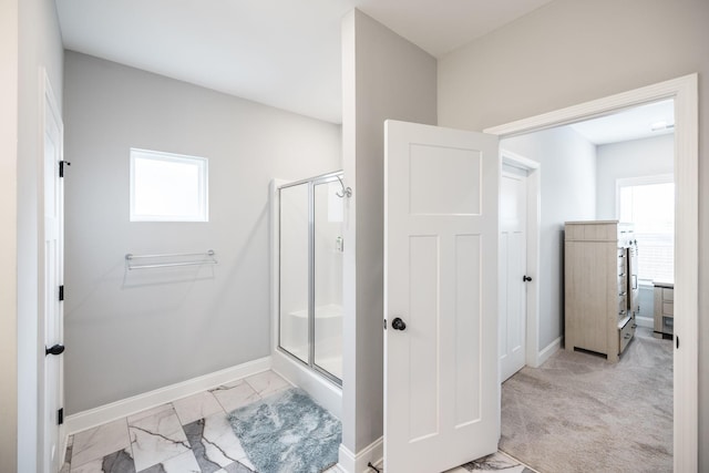 bathroom featuring a shower with shower door