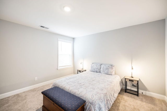 bedroom featuring light colored carpet