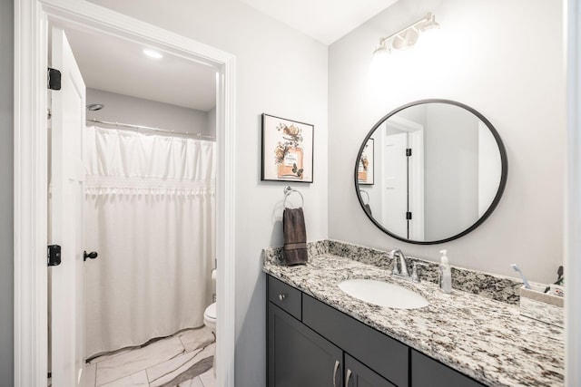 bathroom featuring vanity and toilet