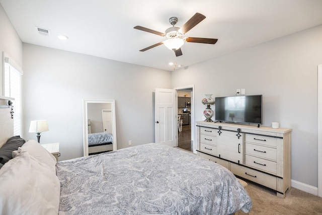 bedroom with ceiling fan and light colored carpet