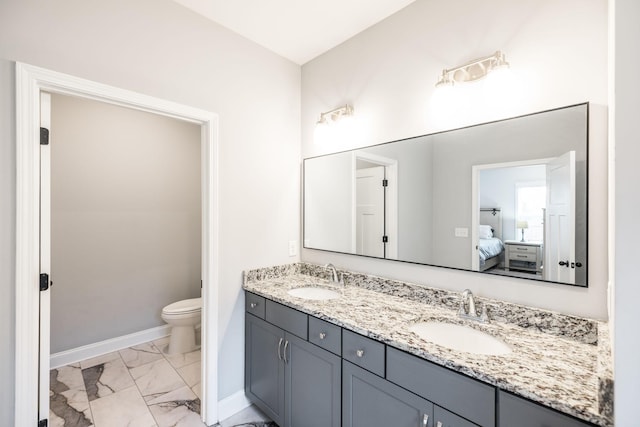 bathroom featuring vanity and toilet