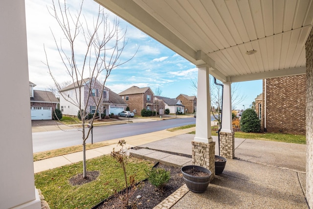 view of patio / terrace featuring a garage and covered porch