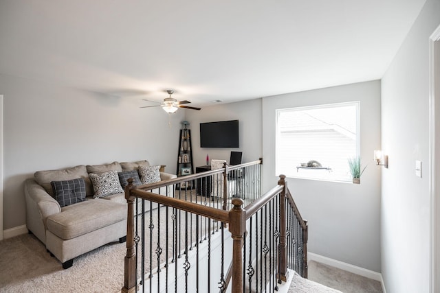 carpeted living room with ceiling fan