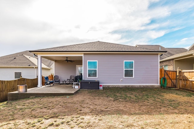 rear view of property with central AC unit, a yard, a patio, and ceiling fan