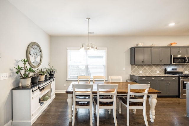 dining area featuring dark wood-type flooring