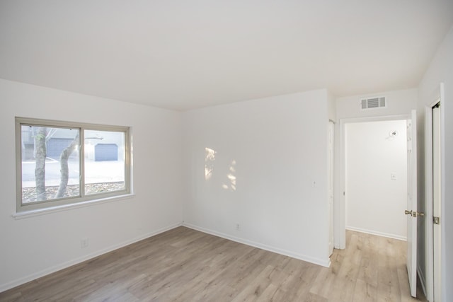 empty room with light hardwood / wood-style floors