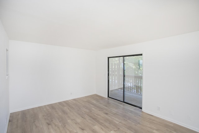 empty room with light hardwood / wood-style flooring