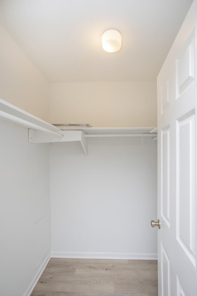 walk in closet featuring light hardwood / wood-style flooring