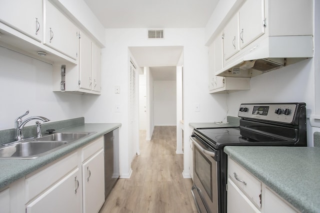 kitchen with sink, light hardwood / wood-style floors, white cabinets, and appliances with stainless steel finishes