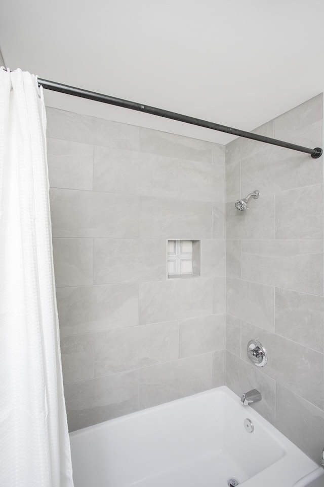 bathroom featuring shower / tub combo with curtain