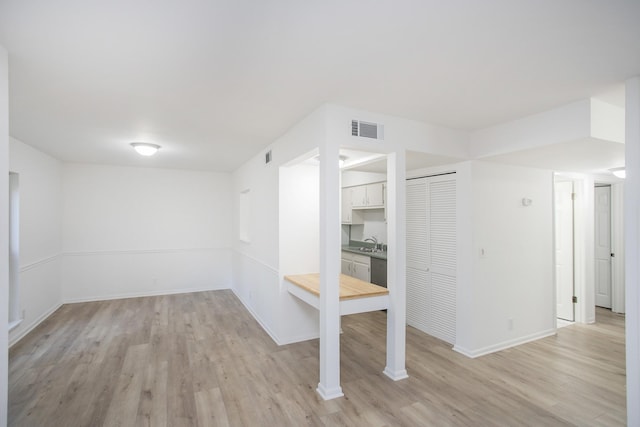 spare room with sink and light wood-type flooring