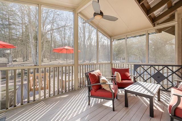 sunroom featuring lofted ceiling with beams and ceiling fan