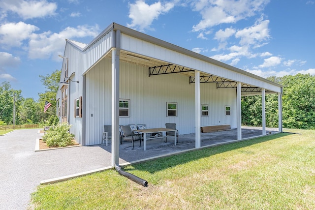 back of property with a patio area and a lawn