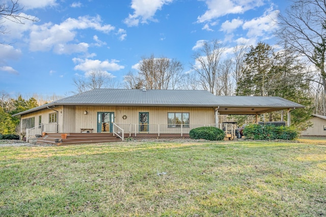 rear view of house featuring a wooden deck and a lawn