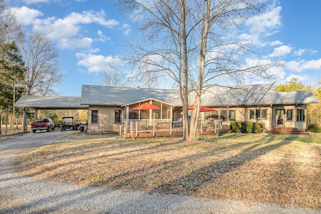 single story home featuring a carport and covered porch