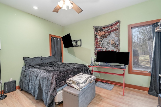 bedroom with ceiling fan and light hardwood / wood-style floors