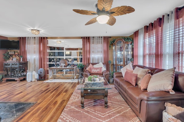 living room featuring ceiling fan and wood-type flooring