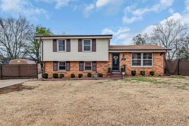 tri-level home with a front lawn