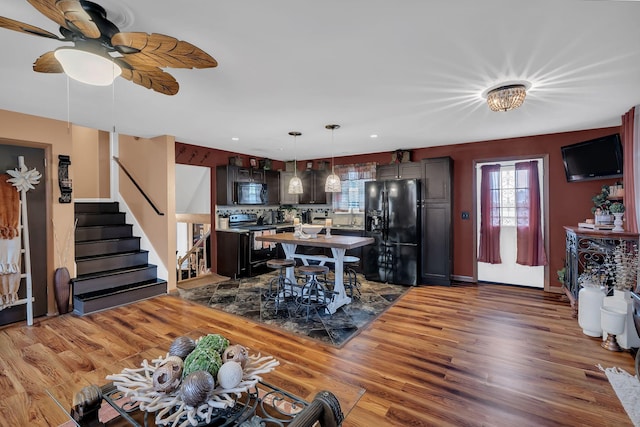 living room with dark hardwood / wood-style floors and ceiling fan