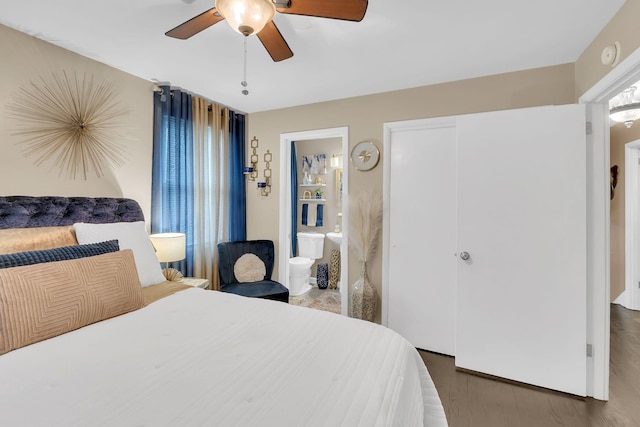 bedroom featuring connected bathroom, dark wood-type flooring, a closet, and ceiling fan